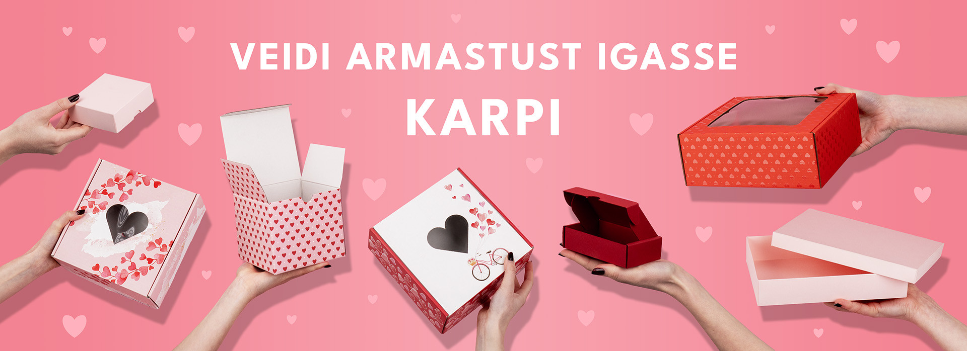 Kätes hoitavad südamekestega kaunistatud karbid roosal taustal, edastades sõnumit „VEIDI ARMASTUST IGASSE KARPI“.