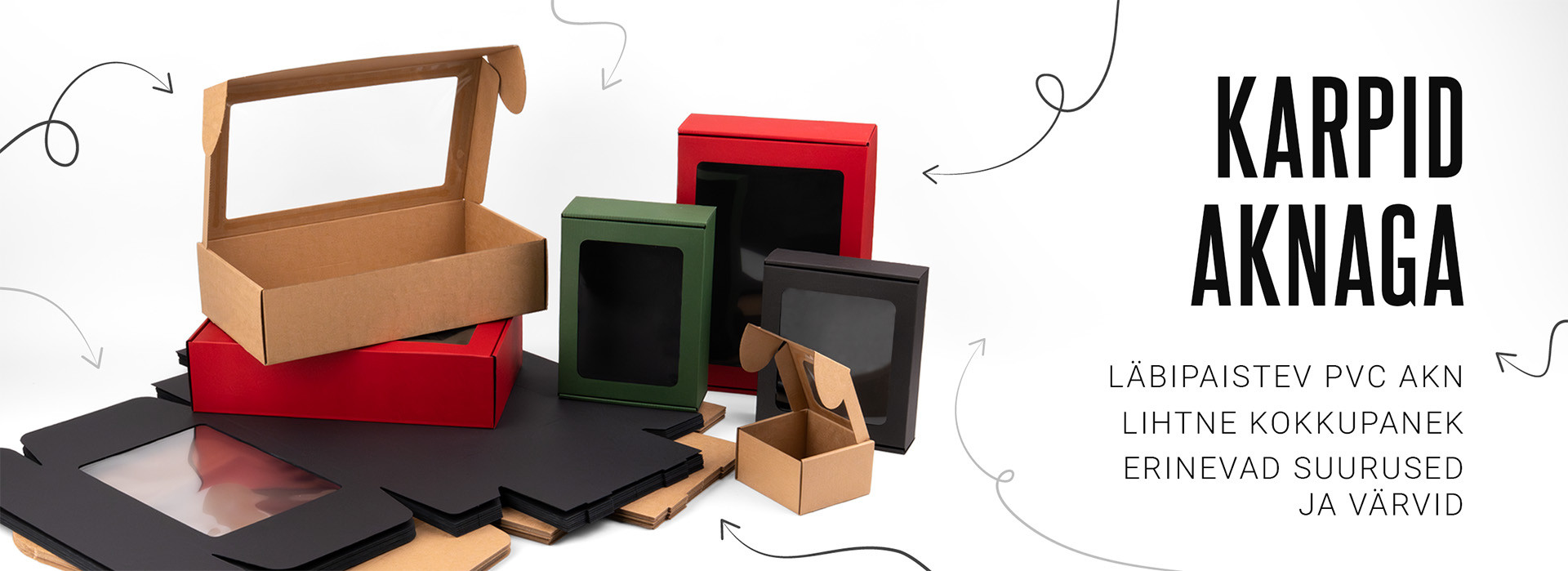 Erineva suuruse ja värviga papist karbid läbipaistvate PVC akendega valgel taustal.