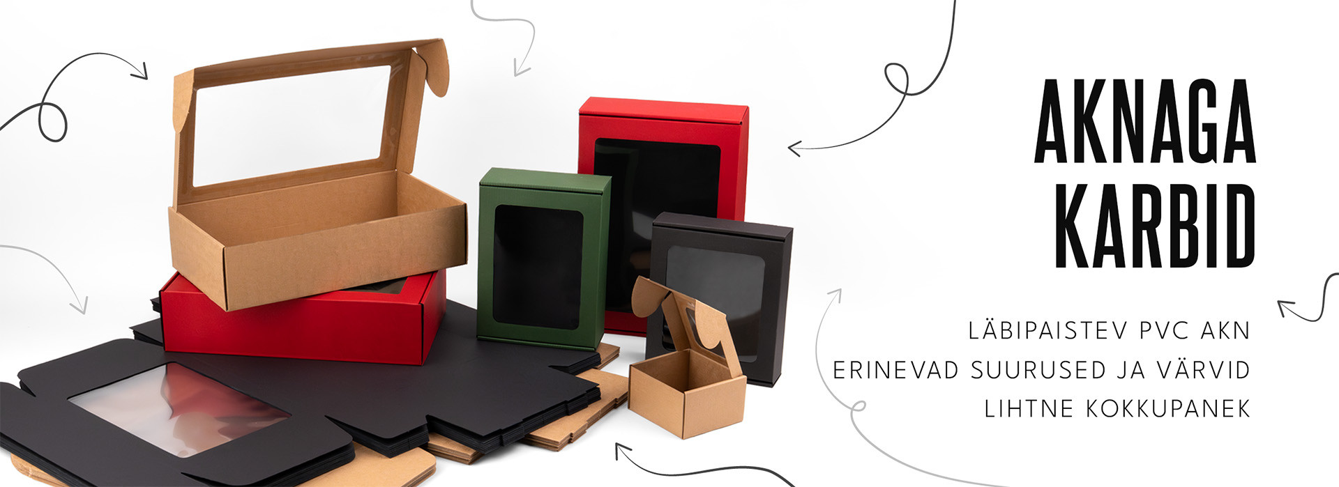 Erineva suuruse ja värviga papist karbid läbipaistvate PVC akendega valgel taustal.